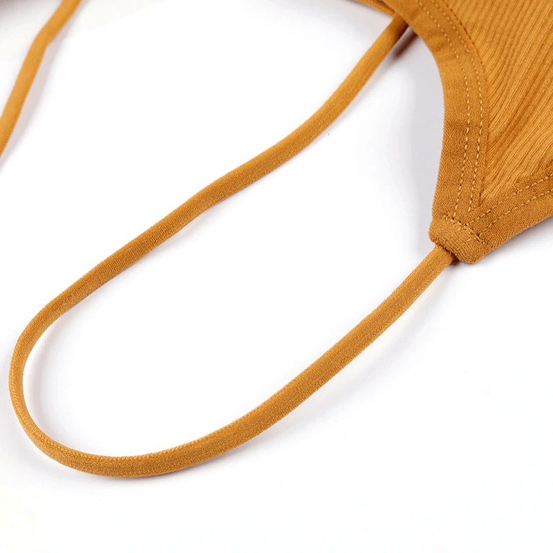 Close-up of stylish wireless orange sports bra with open back, showcasing breathable modal material and strap detail for yoga activities.